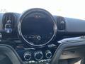 Dashboard of a 2022 Mini Countryman featuring a circular display panel and control knobs in a sleek black design