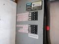Control panel with labeled circuit breakers for various functions including workbench plugs, microwave plug, rear inside plugs, and exterior lights