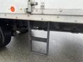 A metal ladder attached to the side of a 2008 Hino 268 truck with a rough texture and a rectangular shape