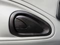 A black plastic door handle panel on a light gray surface with a textured finish for a 2007 International 4200