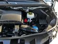 Engine compartment of a 2021 Mercedes-Benz Sprinter featuring various components like the air intake and fluid reservoirs