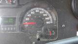 Dashboard of a 2011 Ford Econoline showing a speedometer and odometer with a mileage reading of 148754 km