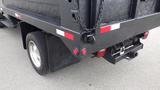 A black 2008 Ford F-450 SD truck with a flatbed rear and visible tow hitch features red and white reflective markings on the sides