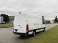A white 2019 Mercedes-Benz Sprinter van viewed from the rear showing its sleek design and high roof.
