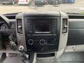 Dashboard of a 2017 Mercedes-Benz Sprinter featuring a central control panel with radio and climate controls along with a gear lever and key fob