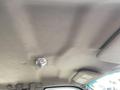 The interior roof of a 2010 Ford F-550 featuring a dome light and a smooth, textured surface