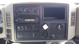 Dashboard of a 2010 International 4400 featuring gauges controls a radio and various switches