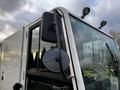 Close-up of a 2007 Tennant Sentinel with a side mirror and overhead lights visible on the front cab area