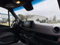 Interior view of a 2019 Mercedes-Benz Sprinter showing the dashboard with a touchscreen display and cup holders