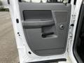 The interior door panel of a 2008 Dodge Ram 5500 featuring a gray plastic design with a door handle and speaker grille