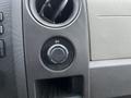 Control panel in a 2010 Ford F-150 featuring a 12V power outlet and circular dial