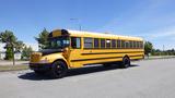 A yellow 2014 International 3000 school bus parked with large windows and black accents on the body