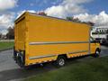 A bright yellow 2017 GMC Savana cargo van with a large rear cargo area and chrome accents parked on a street