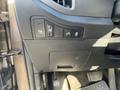 Close-up of the interior panel of a 2012 Kia Sportage featuring control buttons for parking assist and door locks