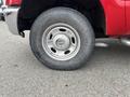 A close-up of a tire on a 2011 Ford F-250 SD with a silver wheel and a black Transforce tire