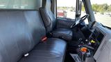 Interior view of a 2019 International 4300 featuring two leather seats and a steering wheel with dashboard controls visible