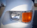 Close-up of the headlight and turn signal of a white 2007 Ford F-650 truck