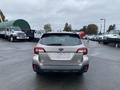 A 2019 Subaru Outback viewed from the rear with a simple design featuring a roof rack and distinctive taillights