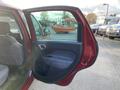 A red 2015 Fiat 500L with the driver's side door open showing the interior and door panel details