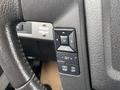 Steering wheel controls of a 2014 Ford F-150 featuring buttons for cruise control and settings