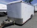 A white 2010 Forest River enclosed trailer with a metallic rear bumper and a hitch at the front