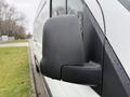 Close-up of the side mirror of a 2019 Mercedes-Benz Sprinter with water droplets on it