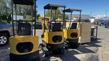 Four yellow 2021 Cael-1T Mini machines lined up in front of vehicles with tracks and a control cabin on top