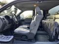 Interior view of a 2008 Ford F-150 XL showing the driver's seat and backseat with gray upholstery and a console between the front seats