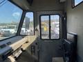 Interior view of a 2010 Freightliner MT45 garbage truck showing the driver's seat dashboard and windshield