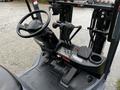 Interior view of a 2017 Toyota 8FCGCU25 forklift showing the steering wheel and control levers