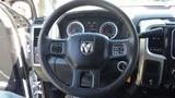 Interior view of a 2014 RAM 5500 dashboard featuring a circular steering wheel with the RAM logo and dashboard gauges behind it