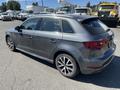 A 2016 Audi A3 hatchback in gray with sporty alloy wheels displayed at an angle showing the rear and side profiles