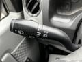 Close-up of the multifunctional control stalk from a 2017 Ford Econoline showing icons for windshield wipers and headlight functions