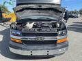 A 2017 Chevrolet Express with the hood raised showcasing the engine compartment and front grille