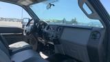 Interior of a 2011 Ford F-450 SD featuring a dashboard with controls and monitors along with leather seats