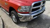 A red 2013 RAM 2500 truck with a chrome grille and bumpers is shown in the foreground with visible tires and fenders