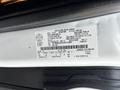 Close-up of a vehicle identification label on a 2020 Ford Transit displaying manufacturing details and specifications