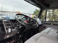 Interior view of a 2001 Freightliner FL80 showing the dashboard steering wheel and control panel