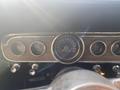 Dashboard of a 1966 Ford Mustang featuring speedometer and various gauges for oil and amperage