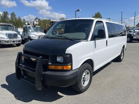A 2012 Chevrolet Express van in white with a black front grille and brush guard showcasing its spacious design and sturdy build