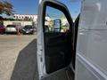 A 2015 Chevrolet Express with the driver's side door open displaying the interior features and driver's seat area