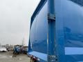 A blue 2011 Freightliner Cascadia Nordic truck viewed from the side focusing on its smooth, glossy surface and structural details