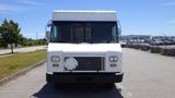 A white 2011 Ford Econoline van with a flat front and rectangular grille parked in a lot