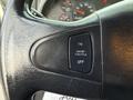 Close-up of the steering wheel of a 2007 International 4200 showing a black button panel with labels for cruise control functions ON OFF and CRUISE/THROTTLE