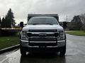 A white 2021 Ford F-550 truck facing forward with a prominent grille and large headlights