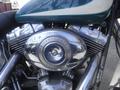 Close-up of a chrome engine of a 2009 Harley-Davidson FLSTC showcasing the distinctive air filter and polished components