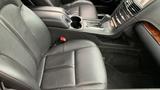 Interior of a 2013 Lincoln MKT featuring black leather seats console cup holders and gear shift