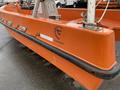 A bright orange 2008 Fassmer 20 Foot Fast Rescue boat with a prominent logo and a sturdy design suitable for rescue operations