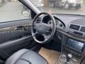 Interior of a 2007 Mercedes-Benz E-Class featuring a leather-wrapped steering wheel dashboard and modern infotainment system