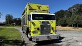 A bright yellow 1995 Freightliner FLL086 truck with a large cargo area and several lights on the roof and front grille